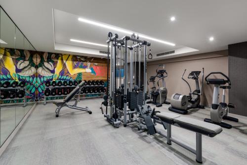 a fitness room with a gym with tread machines at InterContinental Perth City Centre by IHG in Perth