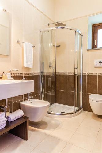 a bathroom with a shower and a sink and a toilet at Villa Ginevra Resort Agrituristico in Ficarra