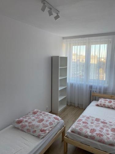 a bedroom with two beds and a window at Krasickiego 12 Gdynia Centrum in Gdynia