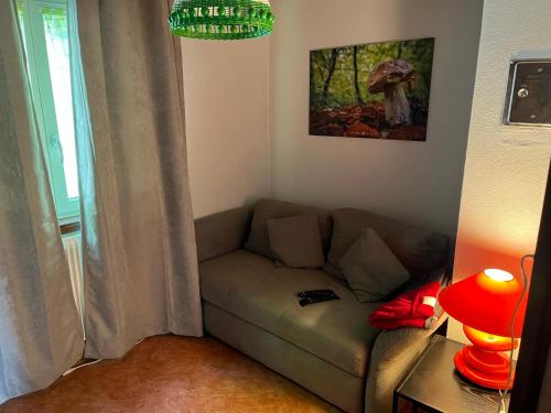 a living room with a couch and a lamp at Chalet chez Jules in Asuel
