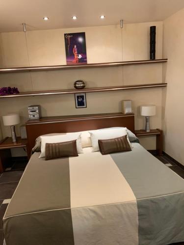 a large bed in a room with two lamps at Loft Chic au Coeur d Orange - HYPERCENTRE - TOUT ÉQUIPÉ in Orange