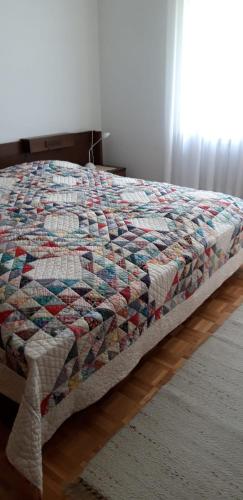 a quilt on a bed in a bedroom at Casa Betulla in Sonogno