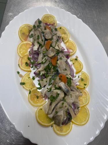 a white plate of food on a table at Pensiunea Califar in Dunavăţu de Jos
