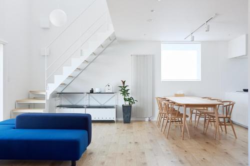a living room with a blue couch and a table at Nippou no Ie Kamishihoro - Vacation STAY 58990v in Kami-shihoro