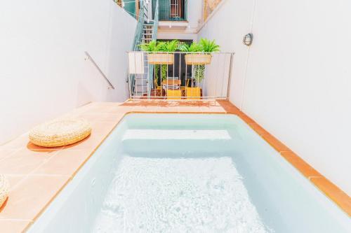 a swimming pool in the middle of a house at Bo&Co Apartments in Sitges