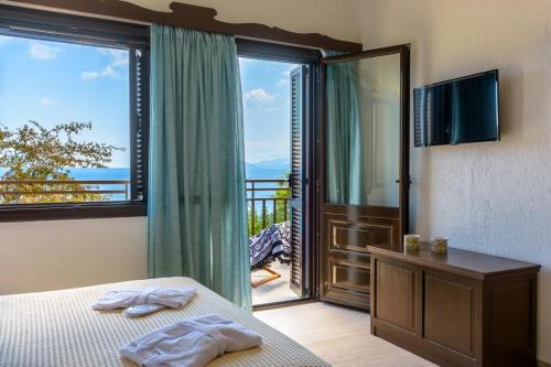 A bed or beds in a room at Ammoudara Bay Villa