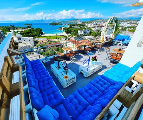 a balcony with blue chairs and a roller coaster at Hotel Mira Mare in Ksamil