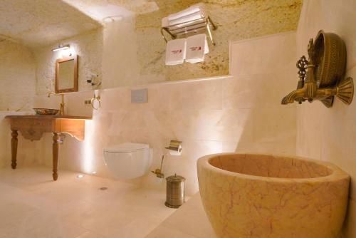 a bathroom with a toilet and a sink and a tub at Fairyland Cave Hotel in Goreme