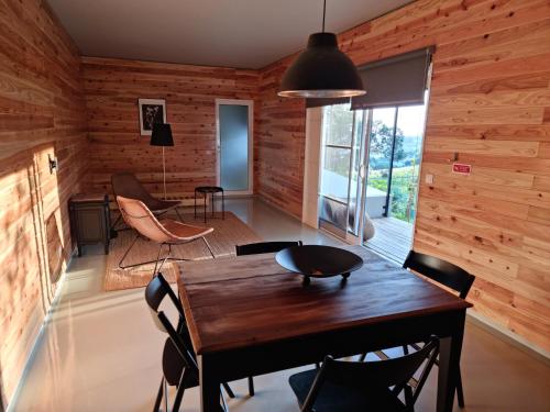 a dining room with wooden walls and a table and chairs at Place of Moments Natur-Suites SPA in Vila Franca do Campo
