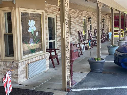 a building with a window with a flower painted on it at White Rose Motel - Hershey in Hershey