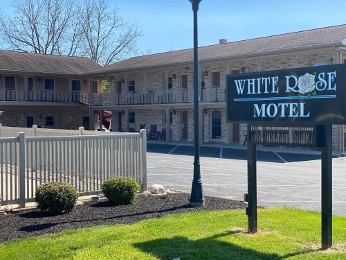 a street sign in front of a white rock motel at White Rose Motel - Hershey in Hershey