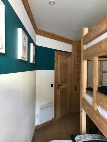 a room with a bunk bed and blue and white walls at Cocoonabay Appartements in Les Angles
