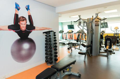 a man on a fitness ball in a gym at Novotel Santos Gonzaga in Santos