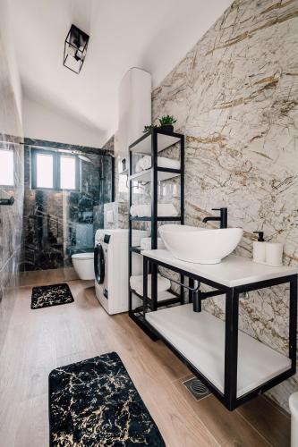 a bathroom with a sink and a shower at Casa Giulia with heated pool in Privlaka