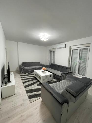 a living room with two couches and a tv at Modern & cozy 2-bedroom vacation home in Sarajevo in Sarajevo