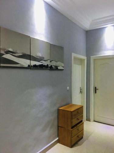 a room with a dresser and a painting on the wall at Villa Cocotiers A11 in Cotonou