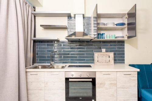 a kitchen with a sink and a stove at CENTRAL ROYAL DREAM -Kiki in Volos