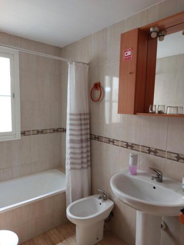 a bathroom with a sink and a toilet and a tub at Home&Holidays Las Gabias, Granada in Las Gabias