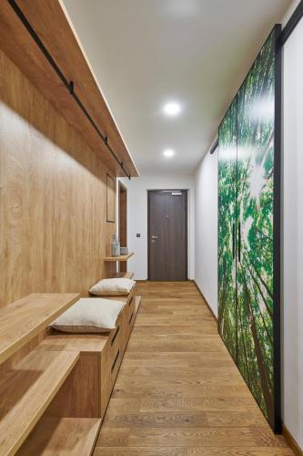 a hallway with wooden flooring and a large painting on the wall at Apartment Adélka 106 Špindlerův Mlýn in Špindlerův Mlýn