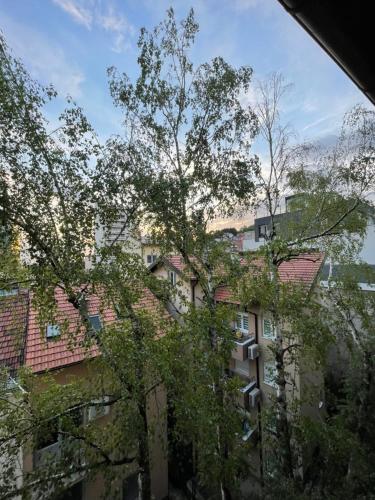 a tall building with trees in front of it at Modern & cozy 2-bedroom vacation home in Sarajevo in Sarajevo