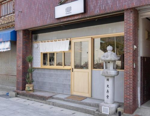 a fire hydrant sitting in front of a building at Coliving & Cafe SANDO - Vacation STAY 26481v in Imabari