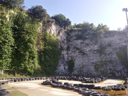 a row of tables and chairs in front of a mountain at AREA MULTISPORT Camping & Camper in Canicattini Bagni