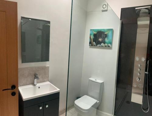 a bathroom with a toilet and a sink with a picture of a dog at Barford barn holiday cottage in Darlington