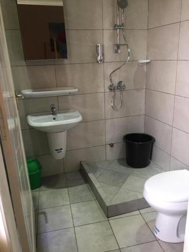 a bathroom with a sink and a toilet at Villa Cocotiers A11 in Cotonou