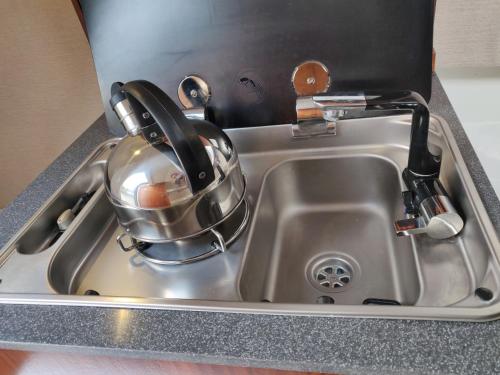 a kitchen sink with a tea kettle on it at Jacht elektryczny bez patentu in Solina