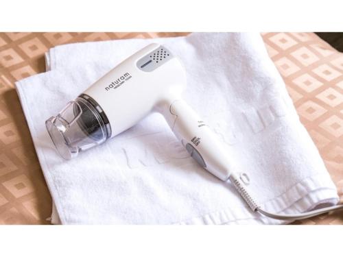 a hair dryer sitting on top of a white towel at Meet Inn Narita - Vacation STAY 43769v in Narita