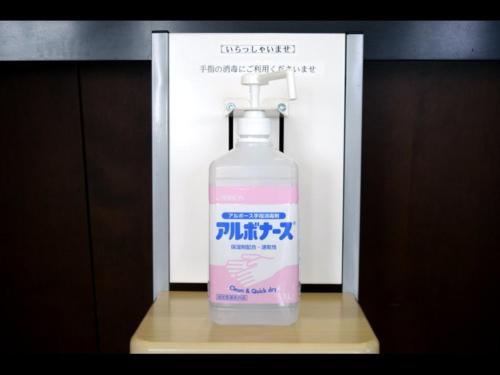 a bottle of water is sitting on a table at Hotel RESH Tottori Ekimae - Vacation STAY 47411v in Tottori