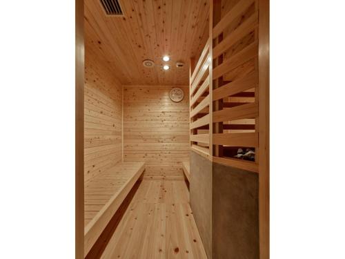 a sauna with a wooden floor and wooden walls at Hotel RESH Tottori Ekimae - Vacation STAY 47411v in Tottori
