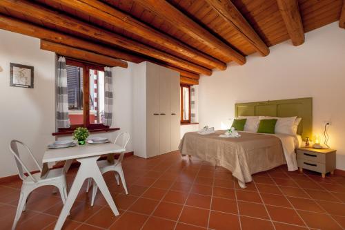 a bedroom with a bed and a table and chairs at Lo Speziale - Paccasassi in Sirolo
