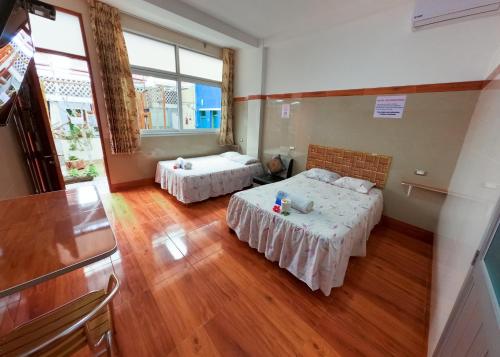 Ένα ή περισσότερα κρεβάτια σε δωμάτιο στο Libélula Hospedaje