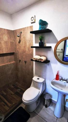 a bathroom with a toilet and a sink at Hermoso Departamento nuevo con acceso a Alberca in Mazatlán