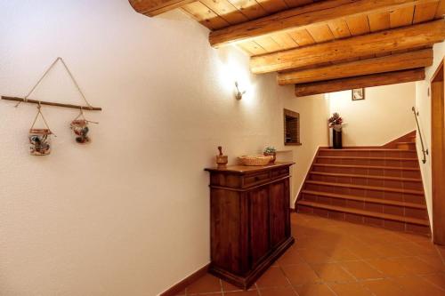 a hallway with stairs and a wooden stair case at Lo Speziale - Paccasassi in Sirolo