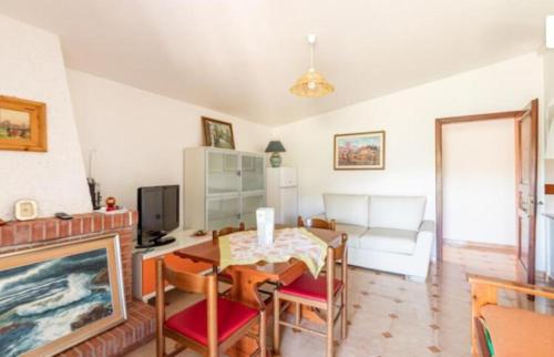 a living room with a table and a fireplace at Casa di Maria a Bosco in San Giovanni a Piro