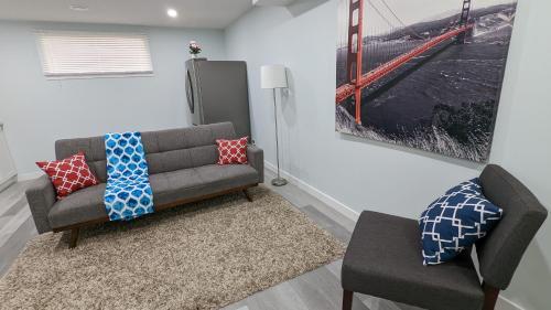 a living room with a couch and a picture of a bridge at SERENE & MODERN 1BED SUITE + CLOSE TO AIRPORT in Regina