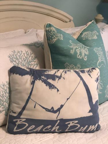 a bed with two pillows on top of it at Beach bungalow at Ocean Village in Fort Pierce
