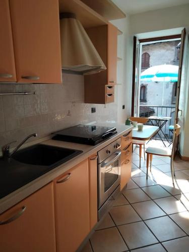 a kitchen with a sink and a stove at Appartamento AZZURRO in Cannobio