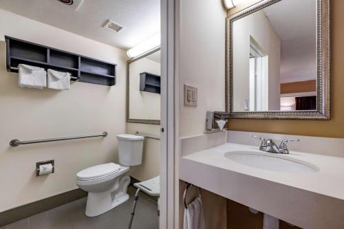 a bathroom with a toilet and a sink and a mirror at Best Western Plus Thousand Oaks Inn in Thousand Oaks