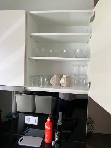 an open refrigerator filled with lots of dishes at Studio RAFAEL Interlaken in Interlaken