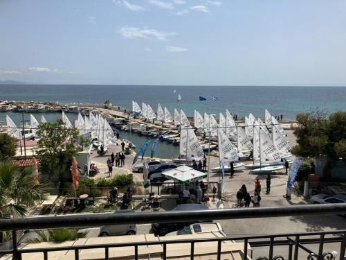a group of sailboats in a marina with people at Vicky's place in Artemida