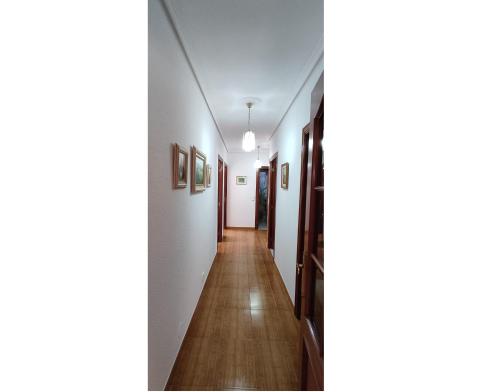 a hallway in a house with white walls and wooden floors at Casa Meri in El Espino