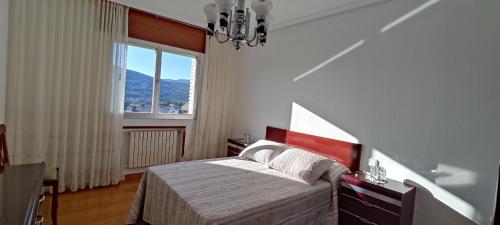a bedroom with a bed and a large window at Casa Meri in El Espino