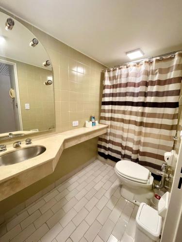 a bathroom with a sink and a toilet and a shower at Obelisco 818 in Buenos Aires