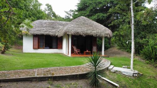 a small house with a grass roof at Hosteria Cumilinche in Same