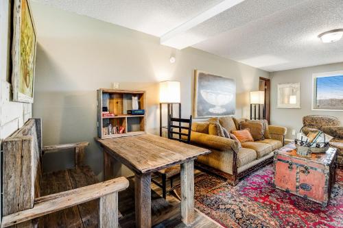 a living room with a table and a couch at Salty Kisses in Ocean Shores