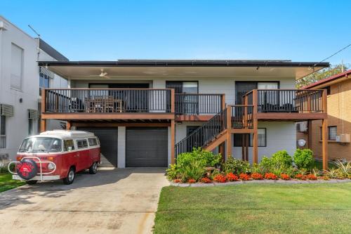 an old red van parked in front of a house at Bayview Beach House - Pet Friendly Holiday Home with a Pool - Holiday Yamba in Yamba