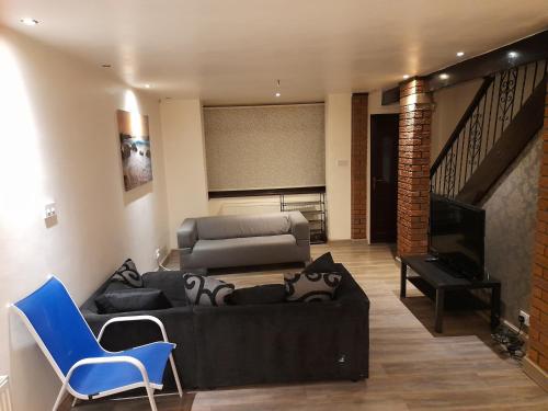een woonkamer met een bank en een piano bij Melverley House in Manchester